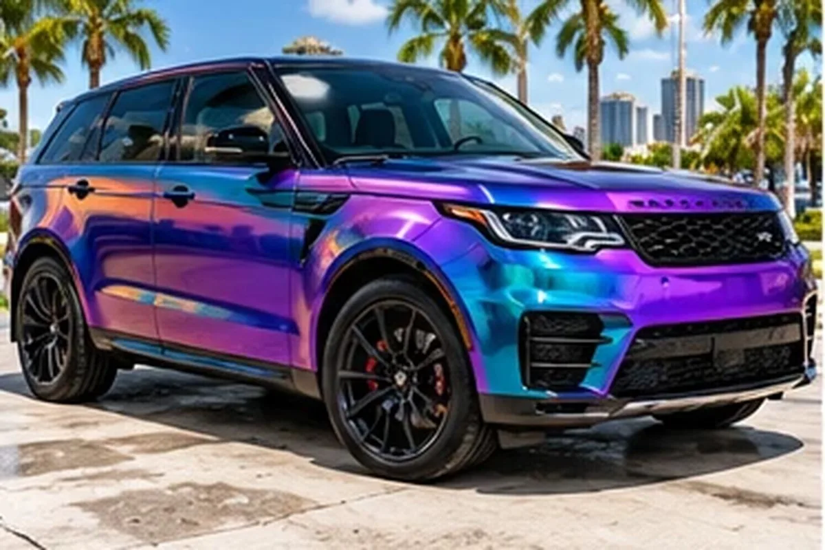 Color-shift purple and teal wrapped Range Rover with San Diego skyline